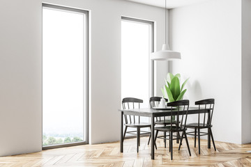 White dining room corner, black table