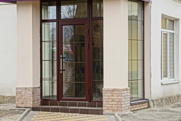 Fototapeta na wymiar glass closed door on the facade of a modern building