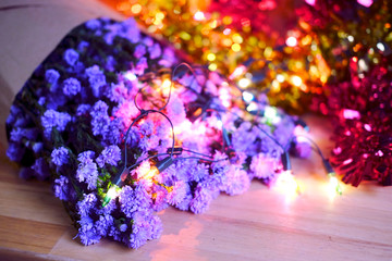 Purple Marguerite Daisy on wood floor and colorful light bokeh background.Use for Valentine day and vintage style with ultra violet concept background.Wooden alphabets & Words.Copy space.