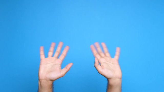 Two male screen on a blue background waiving at the camera. Close up footage