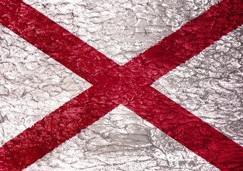 Texture of the Alabama flag on a white wall of rude plaster.
