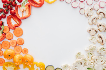 top view of fresh raw sliced organic vegetables isolated on white background