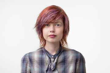 Portrait of in teresting tennager with colored hair and pale skin.