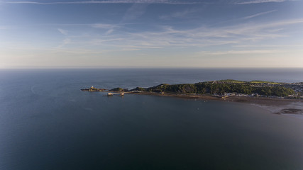 Editorial SWANSEA, UK - JUNE 22, 2018: The coastline along Mumbles showing Mumbles Lighthouse and the newly refurbished Mumbles Pier in Swansea, South Wales, UK