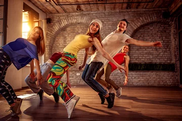 Fototapeten Passion dance team - urban hip hop dancer exercising dance training in studio © luckybusiness