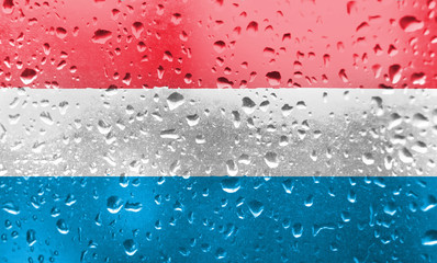 Texture of Luxembourg flag in the pool, water. Splashes.