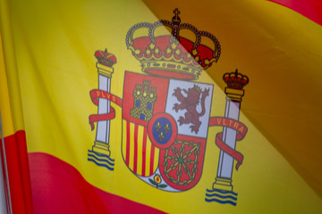 Flag of Spain which waving in the wind on sunny day, background, close-up