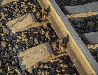 Steel rails and concrete sleepers in the stones on the railway. Fragment of railroad tracks. Railway background