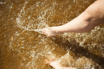 Couple legs splashing the sea water. Summer joy