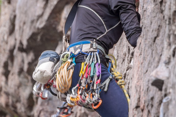 Obraz premium Rock climbing. Climber close-up. Extreme sport. A young climber climbs a vertical granite rock.