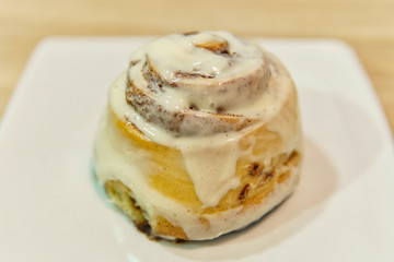 Cinnamon bun on a white plate