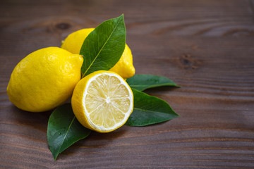 Fresh lemons on wooden background. Copy space