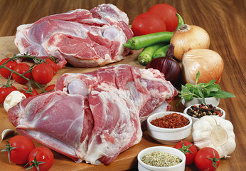 raw lamb leg on board