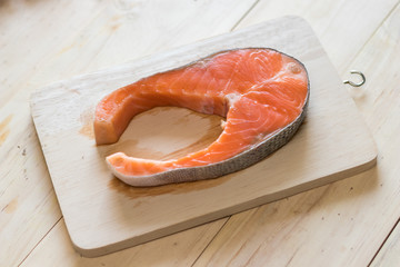 Vitamin D source from salmon fish on wooden background,