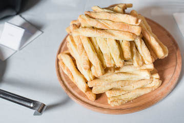 Breadsticks on wooden plate