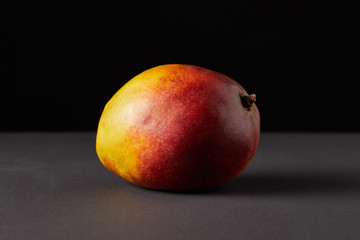 fresh raw of mango on black background