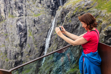 Tourist woman on Trollstigen viewpoint in Norway