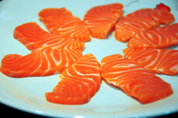 Fresh raw salmon sliced sashimi on dish.