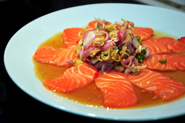 Salmon sliced spicy salad, mixed with the lemon juice, fish sauce and chili. Fusion food in Thailand.