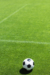 Fototapeta na wymiar high angle view of soccer ball lying on green grass