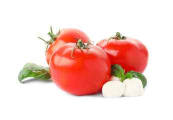Ripe red tomatoes, mozzarella cheese balls and basil on white background