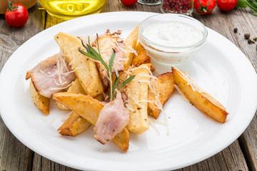 Young fried potatoes with bacon and onions