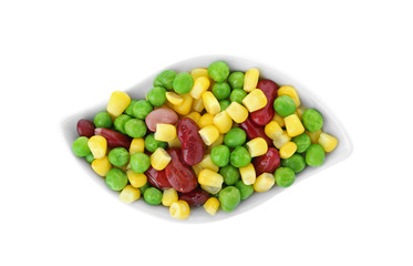 Plate with frozen vegetables on white background, top view