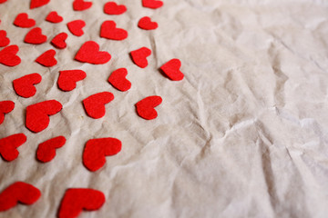 Red paper hearts shape on brown crumpled paper background, Top view.Valentine's day holiday concept. Copy space