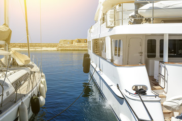The white yachts have being moored on the embankment the Old Town of Chania. Embankmentis located...
