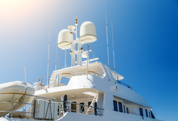 navigation equipment on roof of luxury private yacht, two spheres-details of white yacht against...