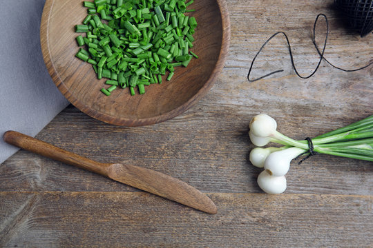 Beautiful composition with fresh green onion on table, top view