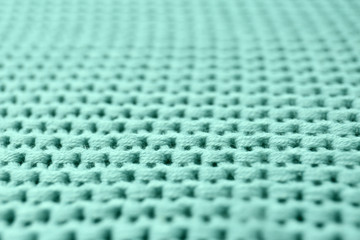 Naklejka premium Knitted mint blue fabric texture as background, closeup