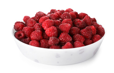 Plate with ripe raspberries on white background
