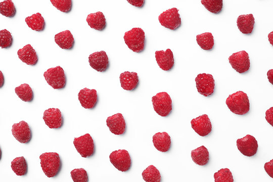Delicious ripe raspberries on white background, top view