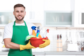 Man in uniform with cleaning supplies indoors