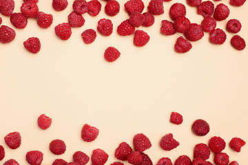 Flat lay composition with ripe aromatic raspberries on color background