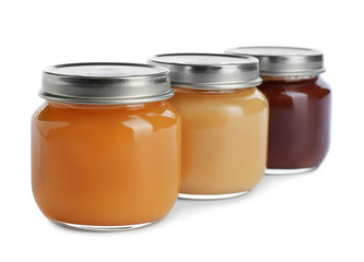 Jars with healthy baby food on white background