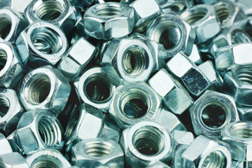 Shiny metal nuts for industrial background. Retro styled