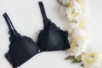 Classic black bra on the white background with peony