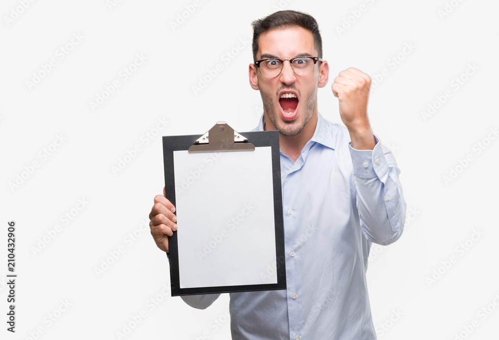 Sticker Handsome young business man showing a clipboard annoyed and frustrated shouting with anger, crazy and yelling with raised hand, anger concept