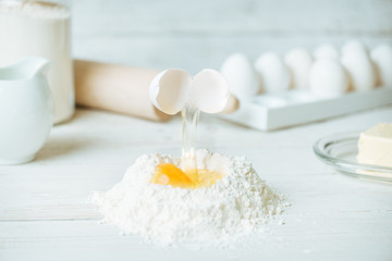 Fototapeta na wymiar Egg into flour. Preparation of the dough. 