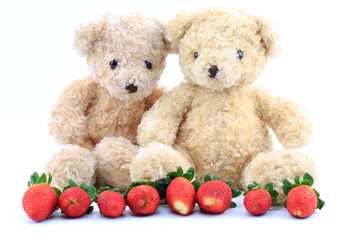 Teddy bear and strawberry on a white background.