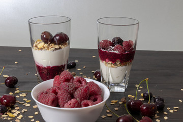 yoghurt with probiotic in a glass beaker with fruit on a dark wooden table