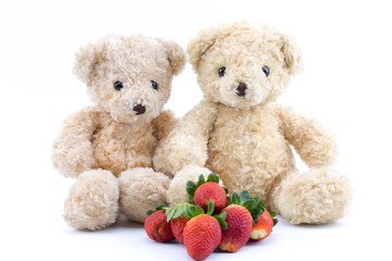 Brown bear and strawberry on a white background.