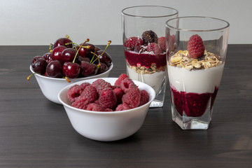 yoghurt with probiotic in a glass beaker with fruit on a dark wooden table