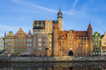 Ancient colored houses on the promenade of the river at dawn in Gdansk