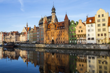 Ancient colored houses on the promenade of the river at dawn in Gdansk