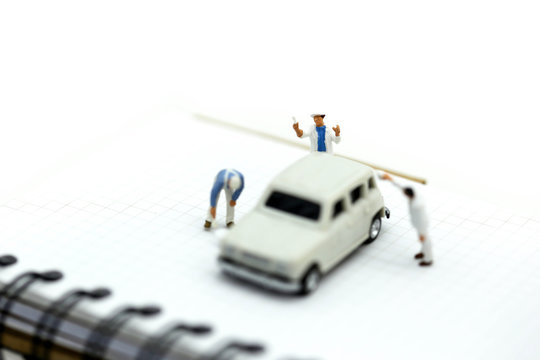 Miniature people : Professional painting car in a paint chamber during.