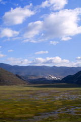 Fototapeta na wymiar Wetland in valley with mountain background at Shangri La, China