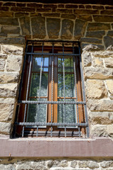 Fototapeta na wymiar Window, window shutter, stone wall
